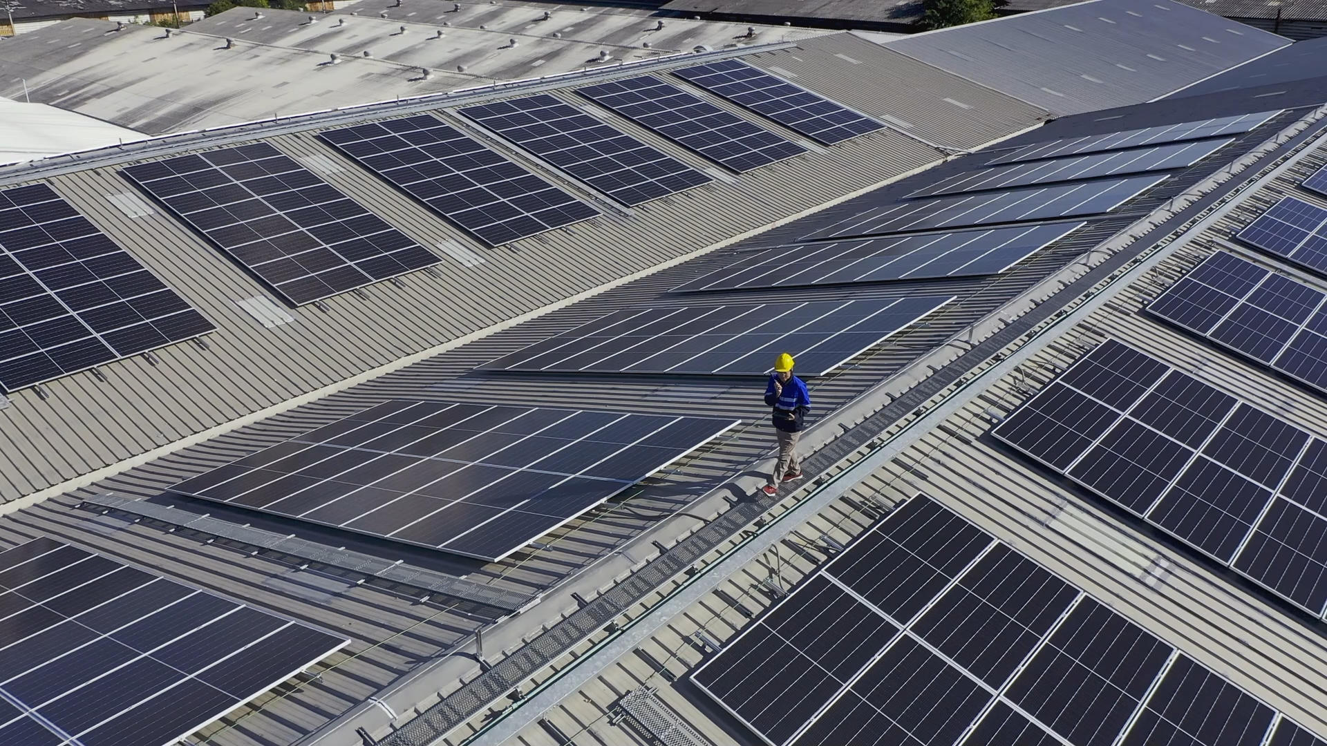 PPA Power Purchase Agreement - Man on roof with solar panels