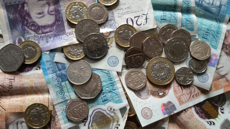 a pile of money on a table to visualise 2025 energy prices