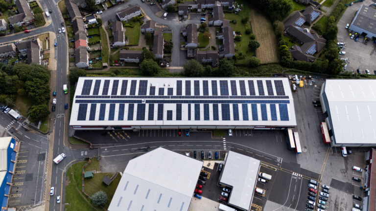 areal shot of commercial solar panels to show renewable energy for CSR