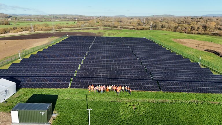 A group photo of attendees at the opening of a large solar farm on Enovert ex-landfill site