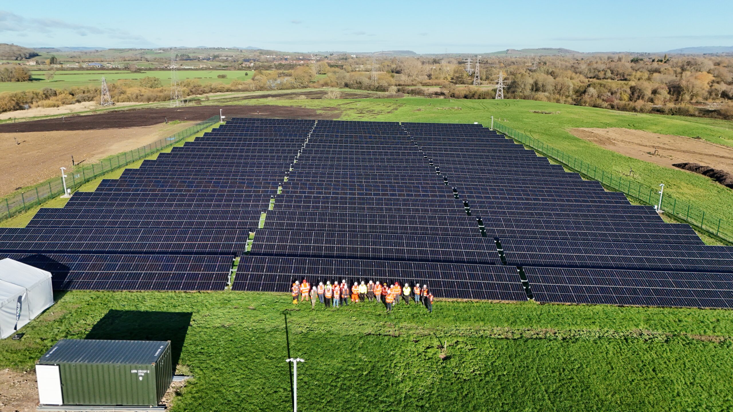 A group photo of attendees at the opening of a large solar farm on Enovert ex-landfill site