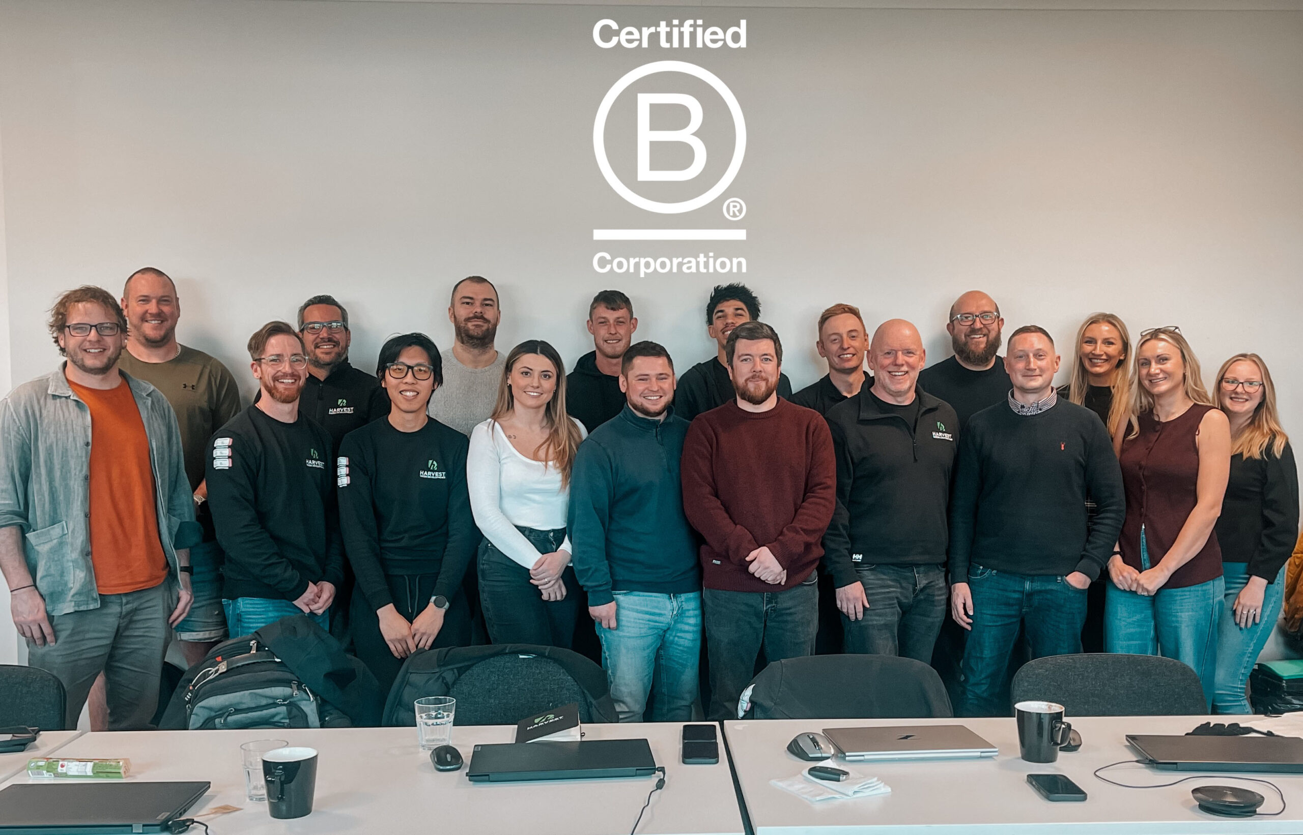 Harvest Green Developments team proudly holding their Certified B Corp business accreditation, reflecting their commitment to people, the planet and purpose-driven renewable energy solutions.